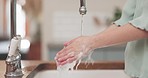 Washing hands, woman and water in home, foam and kitchen for hygiene, health or self care with faucet. Lady, tap and cleaning palm with soap for germs, virus or bacteria at sink for wellness in house