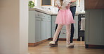 Dance, feet and father with daughter in kitchen for celebration, ballet and energy. Music, princess and trust with man and young girl dancing in family home for support, learning and holding hands