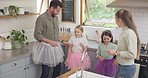 Dance, love and family bonding in the kitchen with a sequence for having fun, jumping and being playful. Happy, smile and girl children dancing with their parents in their modern home or apartment.