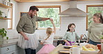 Funny, happy family and parents dancing with children or playing in a kitchen together and excited for a meal or food. Tutu, mother and father with energy bonding with kids love, care and happiness