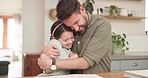 Child, homework and dad hug from student education help in notebook with knowledge development. Paper, study and father support at a table with math parent care for school in a kitchen in home