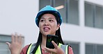Phone call, woman and construction inspection, networking and building site communication in city planning. Engineering, Japanese project manager talking on cellphone speaker or mic at contractor job