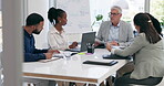 Business people, documents and meeting in team strategy, collaboration or planning together at the office. Group of employee workers in teamwork discussion with paperwork or project plan at workplace