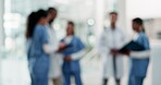 Doctors, nurses and staff talking in a hospital for planning schedule and collaboration with a team. Blurred people or medical workers together for a discussion, conversation or health care at work