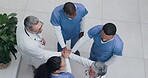 Top view, teamwork or hands of doctors or nurses in collaboration in meeting for healthcare target or goal. About us, team building or medical workers with group support, motivation or clinic mission
