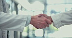 Doctor, handshake and meeting for healthcare deal, agreement or greeting in teamwork at the hospital. Medical professional or people shaking hands in thank you, partnership or promotion at the clinic