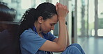 Medical nurse, stress and depression in a hospital corridor for mistake, anxiety or loss and bad news. Female healthcare worker sad, burnout or tired and frustrated with crisis or problem on floor