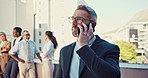 Smile, talking and businessman on a phone call at work for networking or communication. Happy, ceo and an executive mature employee or manager speaking on a mobile at the office for discussion