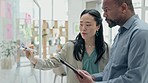 Asian woman, coach and writing on glass for team schedule, brainstorming or planning at the office. Female person coaching or training businessman on board for strategy or project plan at workplace