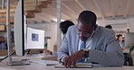 Computer, writing and business with black man in office for research, solution or problem solving. Tech, notebook and planning of african male employee reading information online for data analytics
