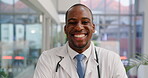 Healthcare, face and funny with a doctor black man laughing while standing in a hospital for an appointment. Medical, portrait and comic with a happy male medicine professional in a clinic for humor