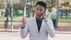 Phone call, park and serious asian business man outdoors for travel, negotiation or planning on commute. Smartphone, traveling and male executive with smartphone conversation unhappy with questions