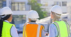 Back, collaboration and a construction worker team planning a building project outdoor in a city together. Architecture, engineering or teamwork with a woman designer talking to partners for safety