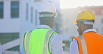 Back, teamwork or architects on construction site planning a building project or renovation together. Architecture, engineering or collaboration of designer talking to contractor for property safety