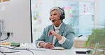 Consultant, senior woman and talking with technology at office for customer service at help desk. Sales, telemarketing and mature employee with headphones at work for crm with technical support.