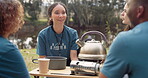 Volunteer, tea and a camp counselor group talking outdoor while planning at an outreach program for the community. Forest, nature or coffee with friends sitting outdoor in conversation about charity