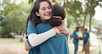 Camping, smile and a counselor hugging a woman outdoor in nature together for love, trust or care. Summer, support and happy friends embracing while bonding at a campsite in the forest or woods