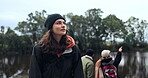 Woman, hiking and friends at a lake in nature for view or peace on a journey. Happy female person with a group for a hike, trekking adventure or travel in countryside for freedom in environment