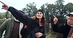 Friends, hiking and people at a lake in nature while calling and pointing at view on journey. Women and a man walking together as a group for a hike, trekking adventure or travel in countryside