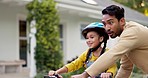 Bicycle, kid learning and father in a garden with young girl with development outdoor. Dad, smile and bike with family with parent support, love and care with safety and cycling with helmer and fun 