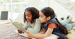 Girl, storytelling and reading book together, sisters at home with bonding and education, literature and fairytale. Development, learning and young female children, childhood and relax at home