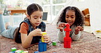 Girl, education toys and playing together, sisters at home with fun, building blocks and development. Learning, creativity and color, female children and quality time, puzzle and games in play room