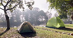 Lake, morning and tent for camping in nature, travel and weekend holiday in summer. Calm, landscape and trekking gear on the grass by river or water for adventure, vacation or recreation in the woods