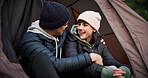 Tent, hug and a couple outdoor for camping in nature with love, care and adventure. Young man and woman happy while at camp site in winter for holiday, travel or vacation to relax and talk in forest