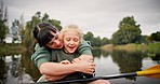 Nature, kayaking and mother hugging her child while floating on a lake by an outdoor forest. Adventure, love and young mom embracing her girl kid on paddle boat on river while on vacation or holiday.