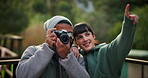 Camera, photographer and couple travel and explore holiday, adventure or vacation location and capture a moment. Getaway, shot and people or tourist taking pictures or photos of nature or wilderness