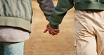 Back of couple, walking and holding hands in park for love, care and relax on romantic date together in nature. Closeup of man, woman and partner stroll in garden for freedom, quality time and trust