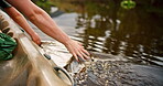 Hands, kayak and palm in lake water on vacation, summer holiday or travel outdoor to relax. Boat, people and fingers touching surface of river waves for adventure, journey and freedom for canoeing.