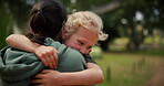 Child, mother and hug at a park outdoor in nature for happiness, adventure or fun play. A woman and girl kid embrace in forest for family travel, wellness and freedom with love, support and care