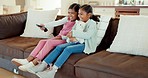 Happy, TV and children on sofa with remote for bonding, quality time and relaxing in living room. Family, childhood and happy girls on couch streaming cartoon movies, entertainment and kids series