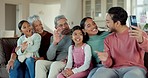Family, group and video call with wave, sofa and together for communication, hello and happy together in home. Men, women and children with webinar, couch and relax in living room with grandparents
