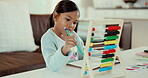 Education, study and math with child and homework for learning, future and growth. Games, development and focus with young girl and abacus in living room at home for kindergarten, school and student