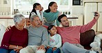 Family, comic selfie and grandparents with children on sofa for bonding, quality time and memory in living room. Home, children and mom, dad and senior parents for silly picture, post or social media