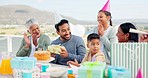 Celebration, birthday and big family at an outdoor party with a dessert cake and presents. Happy, smile and people clapping hands and cheering to celebrate with young man at event outside their home.