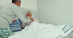 Senior couple, giving and drinking coffee in bedroom at home for morning routine, relax and love. Smile, happy and elderly man serving tea cup beverage to woman in retirement house bed for bonding