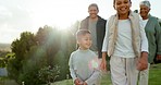 Fun, nature and grandparents walking with their grandchildren in a park on a family vacation. Happy, love and  kids running outdoor while bonding with a senior man and woman in retirement on holiday.