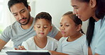 Parents, kids and tablet in bedroom for games, online learning and family streaming multimedia. Mother, father and children relax in morning on digital technology, watching cartoon or movies at home