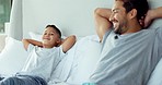 Family, relax and father and son in bed for bonding, quality time and resting in morning together. Happy, bedroom and dad with child lying for happiness, calm and care on holiday, weekend or vacation