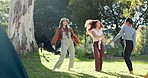 Nature, camp and girl friends dancing together in a forest in nature to music, playlist or album. Happy, freedom and young women moving and jumping to song in the outdoor woods while on weekend trip.