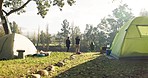 Camping, friends and people relax in nature with tent on outdoor holiday, vacation and adventure, Campsite, traveling and men and women by lake with gear in woods, forest and countryside in summer