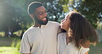 Love, diversity and a camping couple hugging outdoor in nature together while bonding for adventure. Summer, smile or romance with an interracial man and woman in the woods or forest to explore