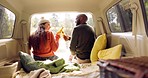 Road trip, beer and couple cheers in car from back, nature and winter adventure together with love, freedom and travel. Camping journey, black man and woman toast alcohol bottle in van, relax at lake