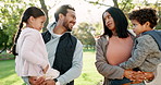 Laughing, love and a family in a park together in summer for bonding, care and walking. Happy, interracial and a mother, father and children on a walk in nature for playing and fun in the morning