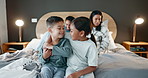 Family, brother and sister on the bed of their parents on a blurred background at night together to relax. Kids, siblings hugging or bonding in the bedroom with mom and dad sitting behind for comfort