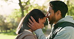 Couple, love and kiss outdoor at a park in nature with care and commitment in marriage. Face of a young man and woman together for happiness, adventure or travel for freedom and relax in a forest