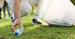 Cleaning, volunteer and man in park with plastic for community service, recycling and sustainability. Eco friendly, charity work and male person with bag for trash, garbage and pollution in nature